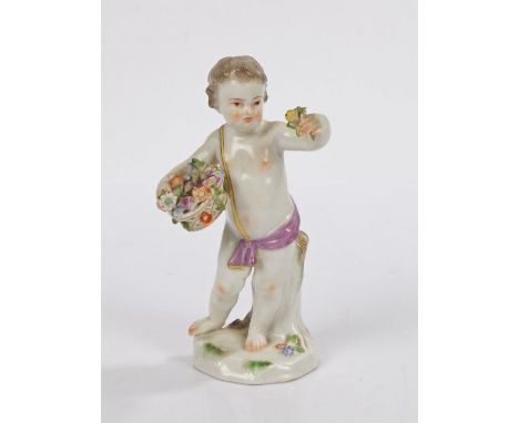 Meissen porcelain figure, of a standing boy holding a basket of flowers, a tree trunk behind and standing on a naturalistic b