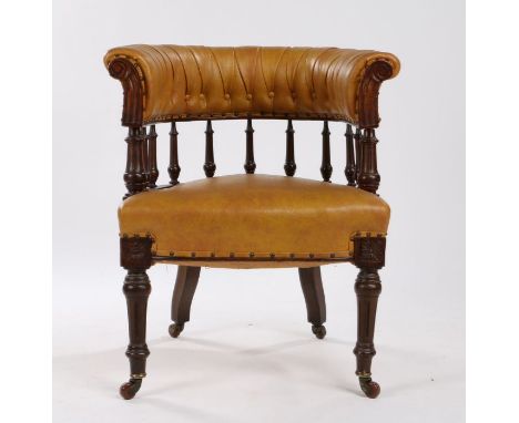 Victorian tan leather desk chair, the curved button back above spindle turned supports and over-stuffed seat, raised on reede