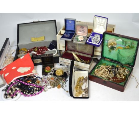 A quantity of costume jewellery, some in jewellery boxes, to include vintage necklaces, brooches and bracelets etc.