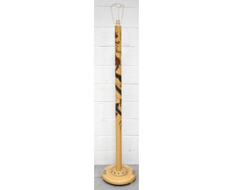 A contemporary cream painted standard lamp in the oriental style decorated with a dragon on rounded base, height 160cm.