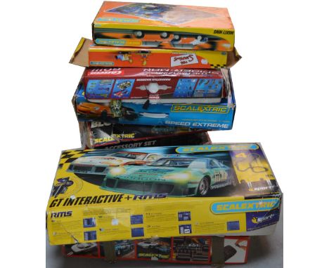 Ten boxed sets of Scalextric to include Formula 1 and the Simpsons examples.