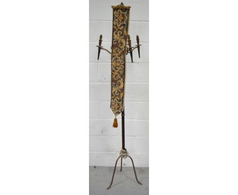A modern metal and brass ecclesiastical style three branch standard lamp with tapestry decoration, height 172cm.
