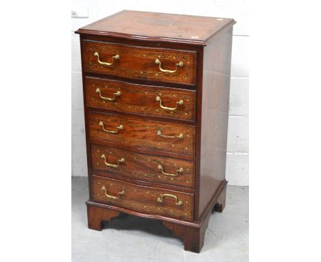 An Indian rosewood serpentine front five drawer chest of drawers inlaid with brass, with brass handles and bracket feet, 94 x