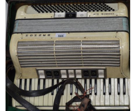 A cased Hohner Carmen IIIM piano accordion.