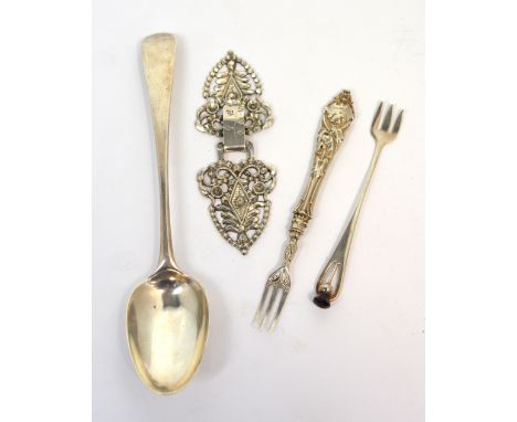 A continental white metal cloak clasp, a pickle fork marked sterling with an amethyst finial in the form of a thistle, a Geor