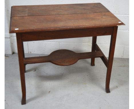 A mahogany side table with lower shaped shelf on curving legs, diameter 90cm.