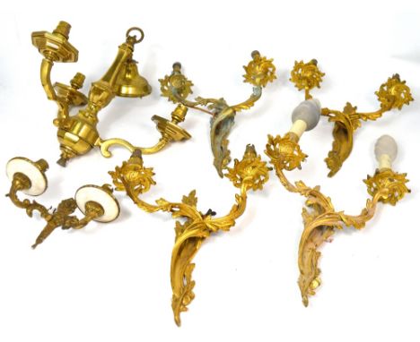 Four ornate gilt metal light fittings, a smaller similar two branch brass example and a three branch brass electrolier (6).