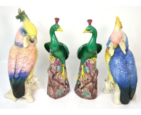 A pair of continental ceramic models of cockatoos and a similar pair of decorative ceramic peacocks, height of all approx 34c