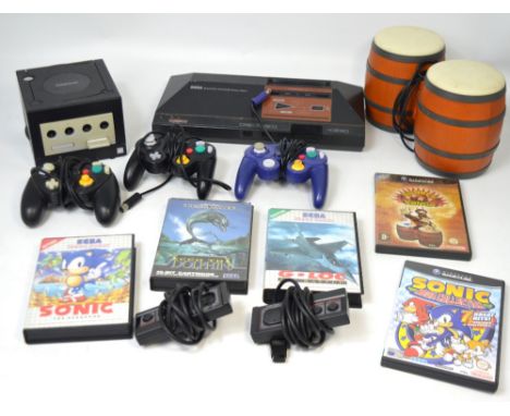 A quantity of vintage game consoles and games to include a Sega Master System and a Game Cube.