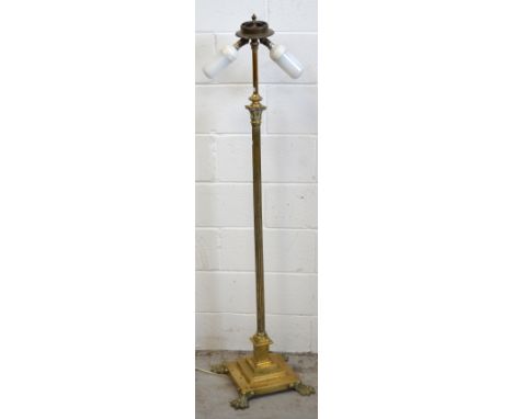 A brass Corinthian column two light standard lamp on stepped base with claw feet, height 145cm.