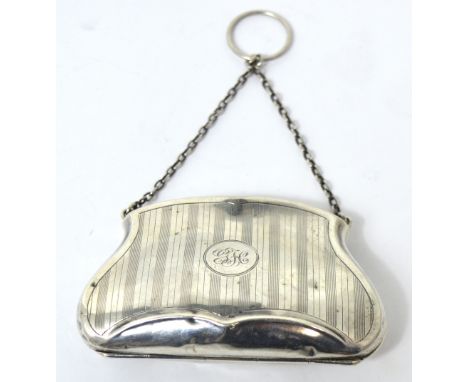 A hallmarked silver engine turned purse with chain handle, three compartments to the interior in brown leather, date marks ru