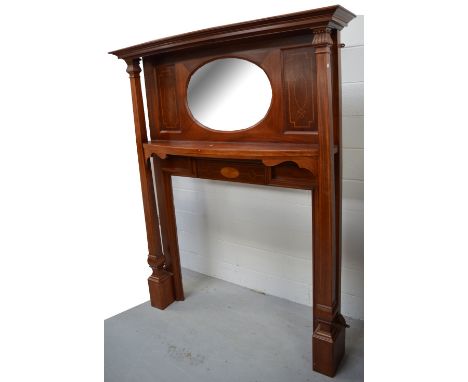 An Edwardian mahogany and inlaid fire surround with central oval bevelled plate, width 155cm, height 190cm approx.