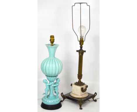 A gilt metal table lamp with fluted column support on ebonised square section base with four outstretched paw feet, height ap
