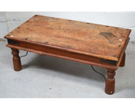A 20th century Indian coffee table on turned legs and metal curving bracket supports, length 100cm.
