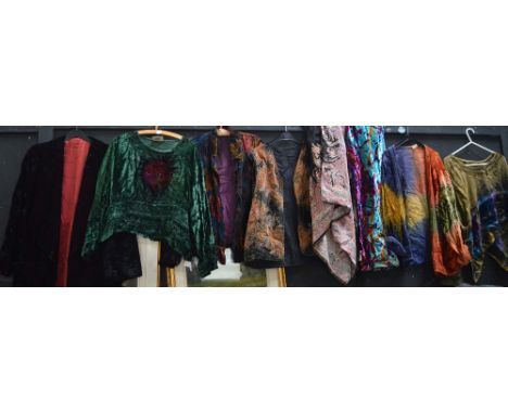 A large quantity of vintage clothes to include many crushed velvet skirts and tops, a straw hat etc.