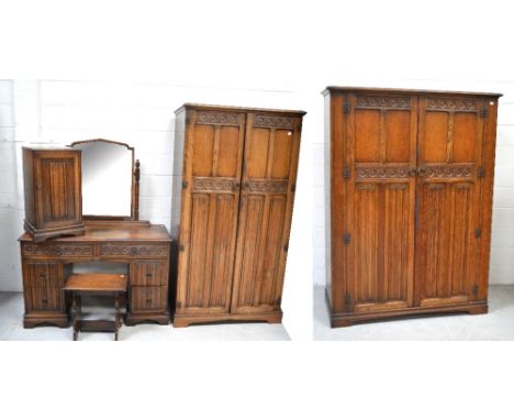 An oak priory style bedroom suite comprising double wardrobe, width 128cm, a single wardrobe, both on bracket feet, a matchin