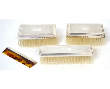 A cased George VI gentleman's toiletry set consisting of three engine turned brushes and a comb, Birmingham 1937.