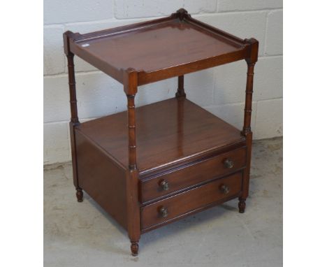 A mahogany side table, the top shelf on ring turned supports and two lower drawers on turned supports.