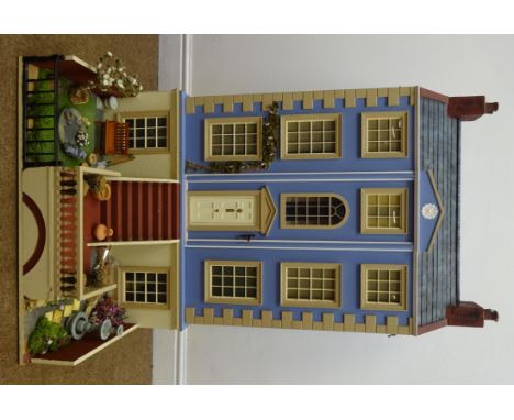 Victorian style wooden double fronted four storey doll's house, with blue painted stucco finish under simulated slate roof, t