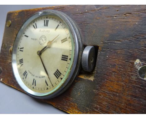 Jaeger aluminium eight day car clock, side wound, mounted on wooden display stand, D8cm 