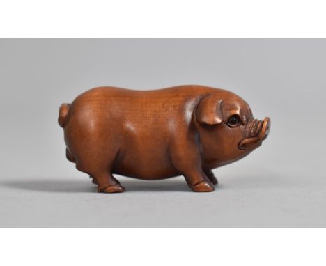 A Carved Wooden Netsuke in the Form of a Standing Boar, Signed, 5.5cm long 
