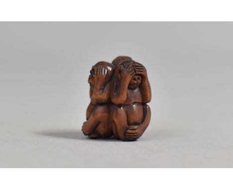 A Carved Wooden Netsuke in the form of Three Monkeys, "Hear No Evil, See No Evil, Speak No Evil", 2cm high 