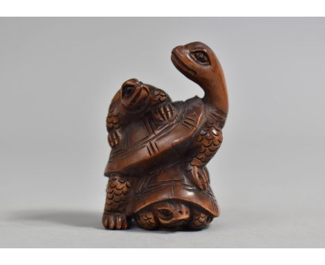 A Carved Wooden Netsuke in the form of Three Tortoises, Signed, 5cm high 