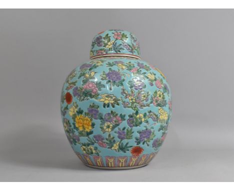 A Large 20th Century Chinese Ginger Jar and Cover Decorated in the Famille Rose Palette on Blue Ground with Blossoming Branch