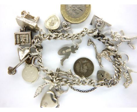 925 silver charm bracelet with seventeen charms to include threepence, sewing machine etc, L: 19 cm, 48g. P&amp;P Group 1 (£1