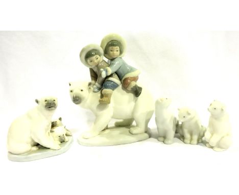 Lladro figural group of two Inuit children atop a polar bear, with further Lladro and Nao polar bear figurines, largest H: 17