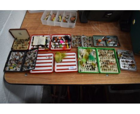 A large selection of fishing flies in metal and plastic fly boxes.