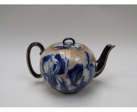 A Royal Doulton Iris pattern teapot, white ground blue and gilt detail 