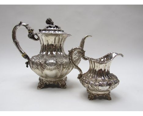 An early Victorian silver teapot and milk jug, each of fluted baluster form, repoussé with shells and scrolls and engraved wi