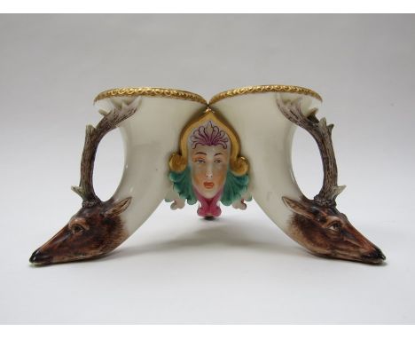 A Royal Worcester triple vase centrepiece, each horn shaped section moulded with a stag's head mask, interspersed with polych