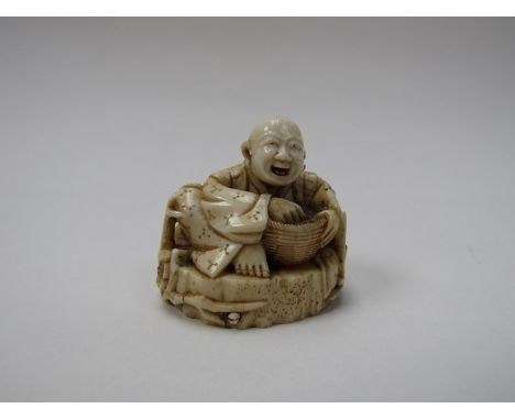 A 19th Century ivory netsuke of a man with rice basket, intricate foliate surround, character marks to base, split to side of