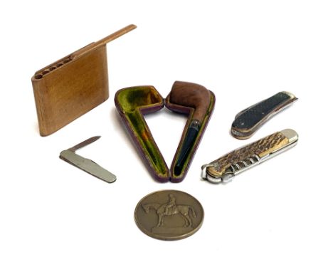 A treen cigarette case, sliding top, slots of ten cigarettes; together with a cased pipe with silver collar, Birmingham 1893;