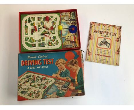 A Merit Toys remote control driving test game, together with The First Muffin Songbook 