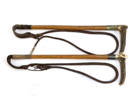 Two ladies hunting whips with bamboo shafts, each with antler handle and brown leather thong, one with silver collar, each ap