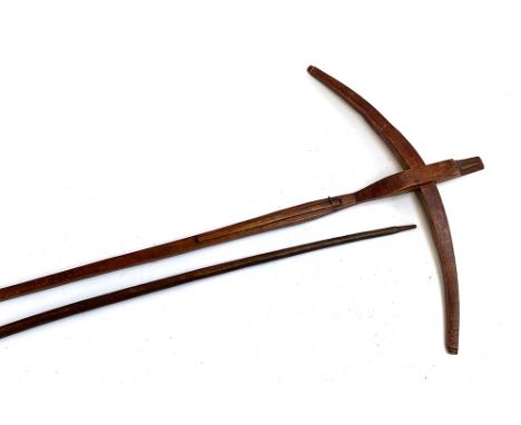 An African Gabon fang style crossbow, approx. 131cmL; together with an African longbow, 140cmL