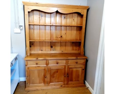 Large pine dresser with 3 cupboards and drawers to the base. Shelves include cup hooks to the top. In two parts, total size i