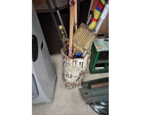 A faux trunk style stick stand and contents including shooting umbrella and vintage hockey stick and golf clubs