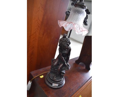 A modern resin lamp, bronzed effect girl on wall study
