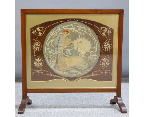 AN ART NOUVEAU WALNUT FRAMED FIRESCREEN, designed by Theodore Barker (1882-1917), the needlework by his sister Edith Firth (n