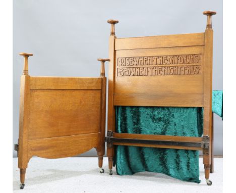 A FINE ARTS AND CRAFTS OAK BED, the headboard carved with the motto 'Rise When The Day Dawns Bed When The Night Falls', the h