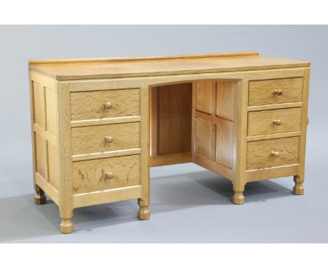 ROBERT THOMPSON OF KILBURNA MOUSEMAN OAK DRESSING TABLE, the adzed rectangular top with canted corners over two banks of thre