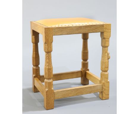 ROBERT THOMPSON OF KILBURNA MOUSEMAN OAK DRESSING TABLE STOOL, the rectangular leather upholstered seat raised on faceted bal