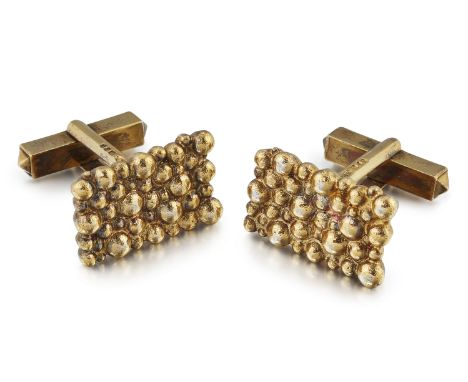 A PAIR OF SILVER-GILT CUFFLINKS, BY STUART DEVLIN, rectangular form with a heavily textured design, to swivel bar links, hall