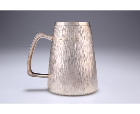 GERALD BENNEY (1930-2008)
AN ELIZABETH II SILVER MUG,&nbsp;London 1971, large, of tapering cylindrical form, the chased bark-