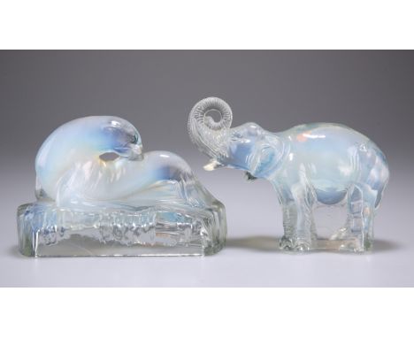 A JOBLINGS OPALIQUE PRESSED GLASS MODEL OF AN ELEPHANT, modelled in standing pose with trunk raised, 10cm by 14cm by 7cm; AND