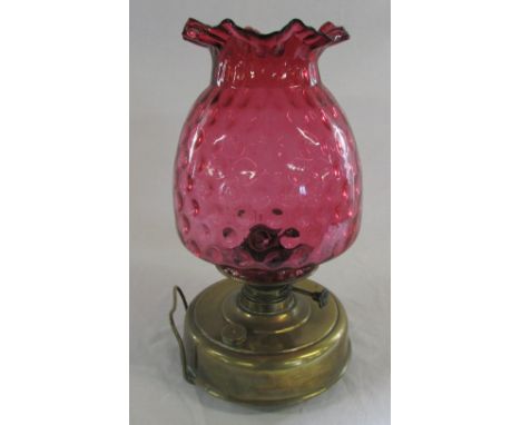 Late Victorian brass oil lamp with cranberry glass shade H 37 cm